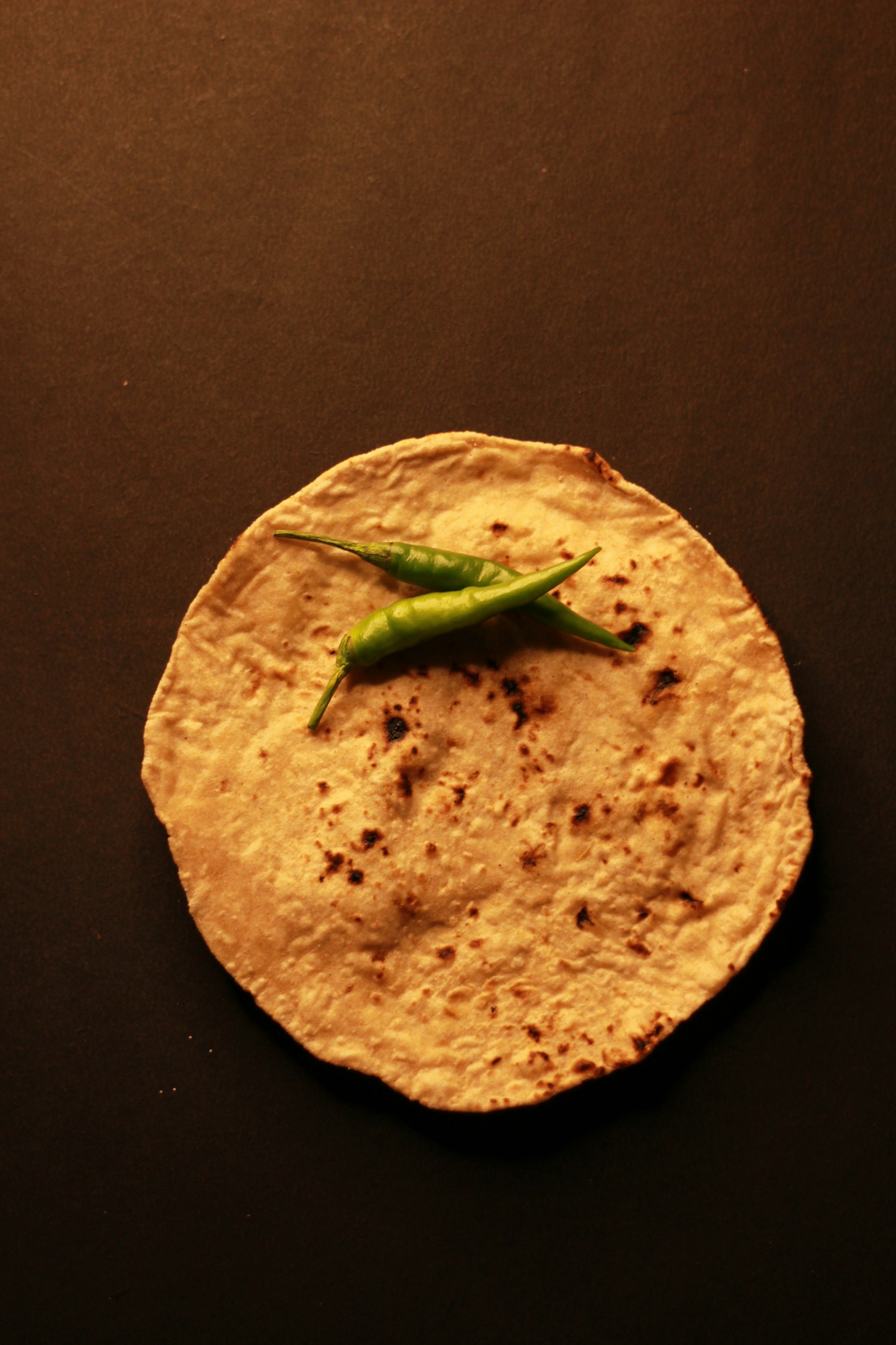 Fresh flatbread cooking on a dark griddle